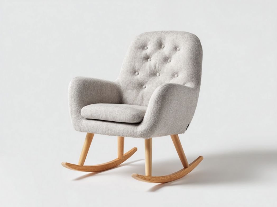 Fauteuil à bascule en tissu gris clair avec dossier capitonné et patins en bois