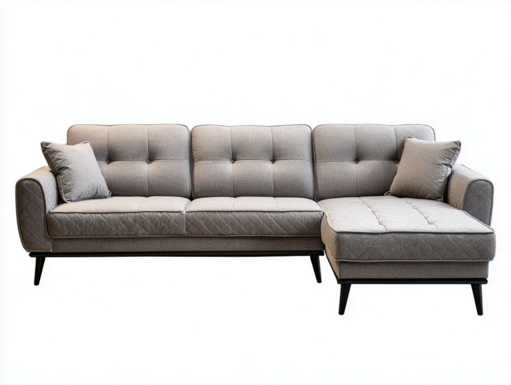 Canapé d'angle en tissu gris avec motif matelassé et coussins inclus