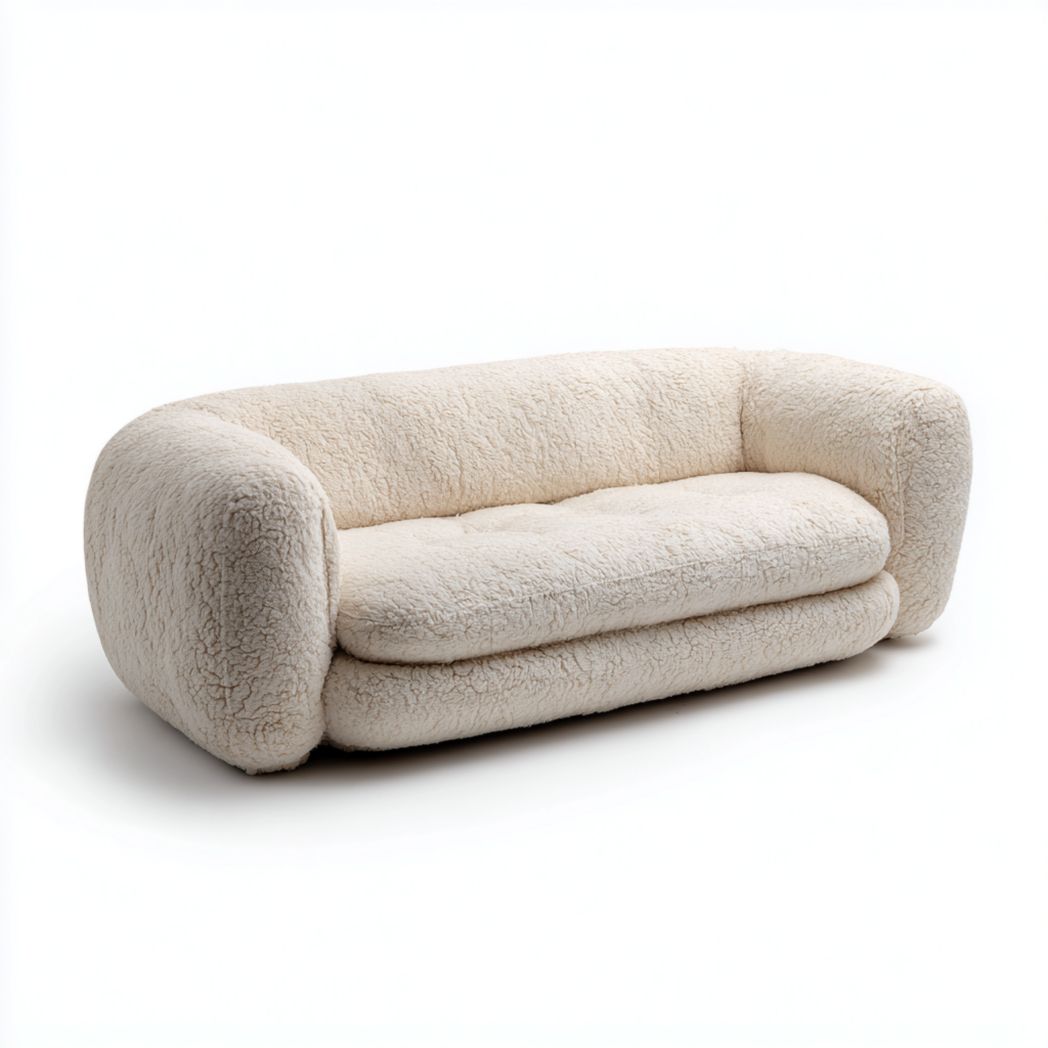 Un canapé droit recouvert d'un tissu texturé imitation peau de mouton blanc cassé, sans coussins.