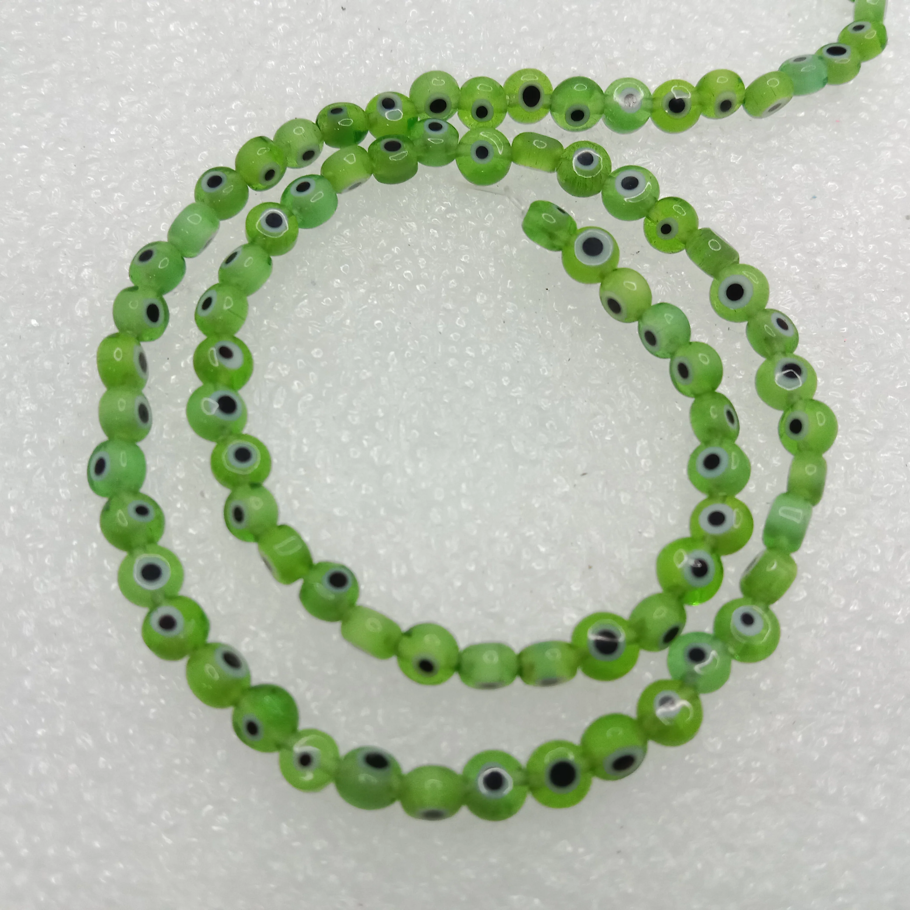 Light green  Evil eye flat shape beads 4mm 1 string
